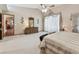 Large main bedroom with neutral carpet, tray ceiling, and decor at 2914 Timber Knoll Dr, Valrico, FL 33596