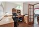 Home office with built-in wooden desk and shelves, next to glass paneled door at 2914 Timber Knoll Dr, Valrico, FL 33596