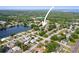 Expansive aerial view of a neighborhood with a lake and lush green surroundings, offering a serene environment at 2964 Catherine Dr, Clearwater, FL 33759