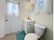 Bathroom featuring a toilet, vanity and window at 2964 Catherine Dr, Clearwater, FL 33759