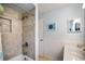 Bathroom featuring tiled shower and tub, a sink with storage, creating a functional and stylish space at 2964 Catherine Dr, Clearwater, FL 33759