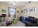 Bright bedroom with a window and multiple framed artwork pieces, offering space for storage at 2964 Catherine Dr, Clearwater, FL 33759