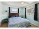 Comfortable bedroom with natural light from two windows, complemented by blue accents and a ceiling fan at 2964 Catherine Dr, Clearwater, FL 33759