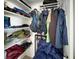 Well-organized closet space with shelving and hanging racks, designed to maximize storage efficiency at 2964 Catherine Dr, Clearwater, FL 33759