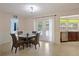 Inviting dining area with a glass-top table, seating for four, and access to the backyard pool area at 2964 Catherine Dr, Clearwater, FL 33759