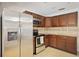 Modern kitchen showcasing stainless steel appliances, granite countertops, and rich wood cabinetry at 2964 Catherine Dr, Clearwater, FL 33759