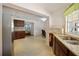 Bright kitchen with granite counters, wooden cabinets, and seamless flow into the dining and living areas at 2964 Catherine Dr, Clearwater, FL 33759