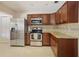 Well-equipped kitchen boasting stainless steel appliances, granite countertops, and wood cabinetry at 2964 Catherine Dr, Clearwater, FL 33759