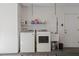 Well-equipped laundry room with modern washer and dryer units, practical sink, and ample storage space; access door included at 2964 Catherine Dr, Clearwater, FL 33759