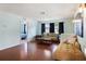 Cozy living room with hardwood floors, a plush sofa, and access to other rooms creating an open floor plan at 2964 Catherine Dr, Clearwater, FL 33759