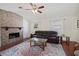Comfortable living room with brick fireplace and dark brown leather seating at 2964 Catherine Dr, Clearwater, FL 33759