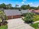 Stunning home in a golf community, with a screened-in pool, lush landscaping, and a three car garage at 3168 Masters Dr, Clearwater, FL 33761