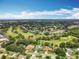 Aerial view of homes near a golf course with mature trees, showcasing the neighborhood's landscape at 3168 Masters Dr, Clearwater, FL 33761