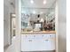 Elegant bar area with mirrored backdrop, marble countertop, and white cabinetry at 3168 Masters Dr, Clearwater, FL 33761