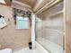 Bathroom featuring a shower/tub with sliding glass doors and decorative nautical decor at 3168 Masters Dr, Clearwater, FL 33761