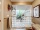 Shower area with a glass block entry, pebble floor and tropical plants at 3168 Masters Dr, Clearwater, FL 33761
