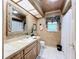 Bathroom featuring a vanity with decorative mirror and a shower with sliding glass doors at 3168 Masters Dr, Clearwater, FL 33761