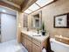 Traditional bathroom featuring an ornate mirror, single vanity, and decorative accents at 3168 Masters Dr, Clearwater, FL 33761