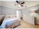 Relaxing bedroom with light blue walls, ceiling fan, wood floors and soft, natural light at 3168 Masters Dr, Clearwater, FL 33761