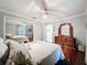 Bedroom featuring hardwood floors, ceiling fan, and a dresser with a decorative mirror at 3168 Masters Dr, Clearwater, FL 33761