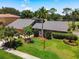 Beautiful home with well-manicured lawn, mature trees, and lush landscaping in a golf community at 3168 Masters Dr, Clearwater, FL 33761