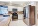Modern kitchen featuring stainless steel appliances, tile flooring and a breakfast bar for easy meals at 3168 Masters Dr, Clearwater, FL 33761
