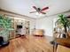 Living room with wood floors, ceiling fan, and built-in shelving, featuring decorative plants and furniture at 3168 Masters Dr, Clearwater, FL 33761