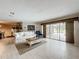 Bright and airy living room with tile floors and views of the lanai and pool at 3168 Masters Dr, Clearwater, FL 33761