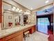 The main bathroom features a large vanity area and is adjacent to the pool at 3168 Masters Dr, Clearwater, FL 33761