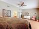Comfortable main bedroom with wood floors and decor, adjacent to the main bathroom at 3168 Masters Dr, Clearwater, FL 33761