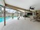 Spacious covered patio, perfect for entertaining, featuring ceiling fans and scenic views of the pool at 3168 Masters Dr, Clearwater, FL 33761