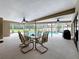 Large screened patio with ceiling fans and views of the pool and surrounding lush outdoor space at 3168 Masters Dr, Clearwater, FL 33761