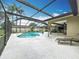 Enclosed screened-in pool with ample patio space offers the perfect relaxation and entertainment setting at 3168 Masters Dr, Clearwater, FL 33761