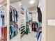 Large walk-in closet featuring custom shelving and hanging storage for clothes and shoes at 3168 Masters Dr, Clearwater, FL 33761