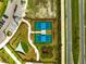Aerial view capturing tennis courts, playground, walkways, and parking, providing recreational opportunities at 31779 Asbury Ave, Wesley Chapel, FL 33545