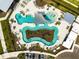 Aerial view showcasing the community pool with lounge areas, lush landscaping, and convenient parking at 31779 Asbury Ave, Wesley Chapel, FL 33545