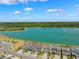 Aerial view showing the homes with a stunning view of a serene lake and lush green trees at 31779 Asbury Ave, Wesley Chapel, FL 33545