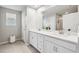 Bathroom featuring double sinks, granite countertops, and tile floors at 31779 Asbury Ave, Wesley Chapel, FL 33545