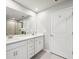 Bathroom featuring double sinks, granite countertops, and tile floors at 31779 Asbury Ave, Wesley Chapel, FL 33545