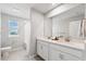 Bright bathroom featuring double sinks, quartz countertops and shower-tub combination at 31779 Asbury Ave, Wesley Chapel, FL 33545