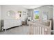 Neutral toned Bedroom with a dresser, crib, and natural lighting at 31779 Asbury Ave, Wesley Chapel, FL 33545