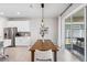Contemporary dining space featuring a wooden table and chairs with stainless steel appliances in the background at 31779 Asbury Ave, Wesley Chapel, FL 33545