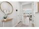 Bright entryway flows to the living area with neutral walls, tile flooring, and stylish decor at 31779 Asbury Ave, Wesley Chapel, FL 33545