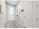 Bright entryway featuring neutral walls, tile flooring, and stylish decor at 31779 Asbury Ave, Wesley Chapel, FL 33545