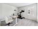 Bright room set up as a home gym and workspace with neutral decor at 31779 Asbury Ave, Wesley Chapel, FL 33545