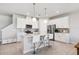 Well-lit kitchen with white cabinetry, a stainless steel refrigerator, and tiled backsplash at 31779 Asbury Ave, Wesley Chapel, FL 33545