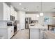Modern kitchen featuring stainless steel appliances, white cabinetry, and a gray backsplash at 31779 Asbury Ave, Wesley Chapel, FL 33545
