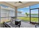Covered lanai provides a serene outdoor space overlooking a spacious backyard and lake at 31779 Asbury Ave, Wesley Chapel, FL 33545