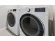 Modern laundry room featuring side-by-side LG washer and dryer sets at 31779 Asbury Ave, Wesley Chapel, FL 33545