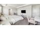 Spacious main bedroom with a tray ceiling, a desk, a TV, and neutral decor at 31779 Asbury Ave, Wesley Chapel, FL 33545